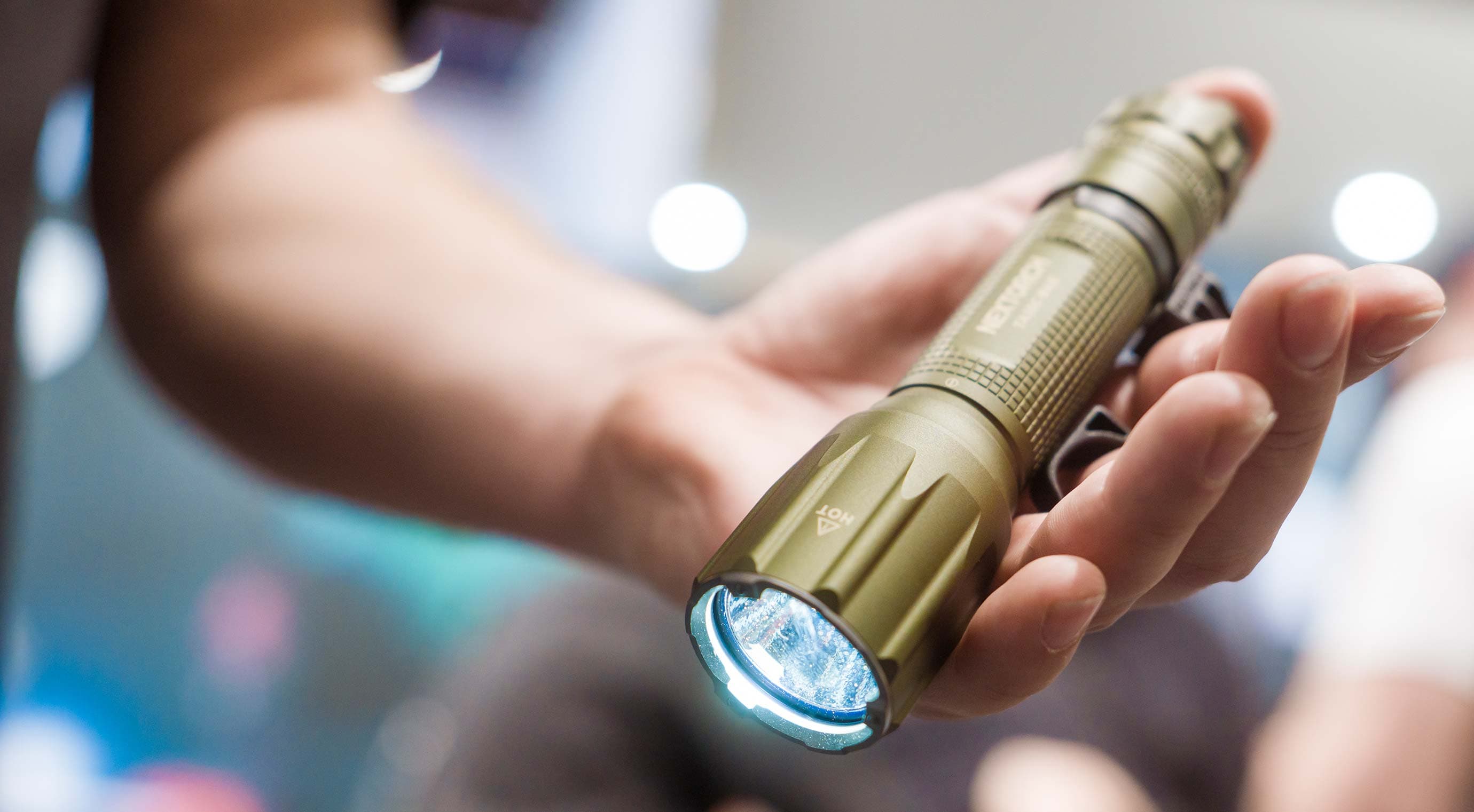 Close-up of a flashlight that someone is holding in their hand