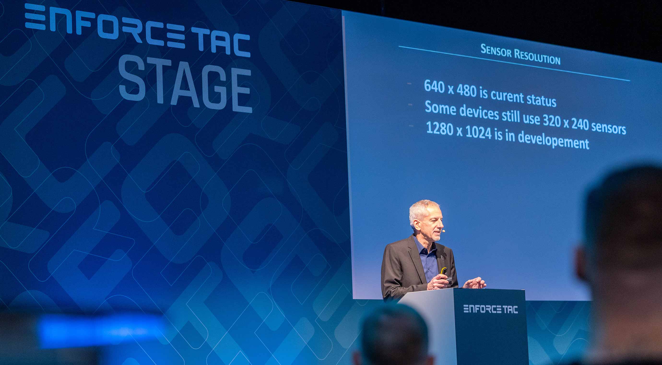A speaker on the Enforce Tac Stage gives a presentation on sensor resolution